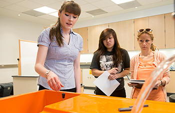 Two female engineering students observe a <a href=