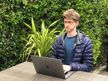 Joey Meyer working on his Apple laptop.